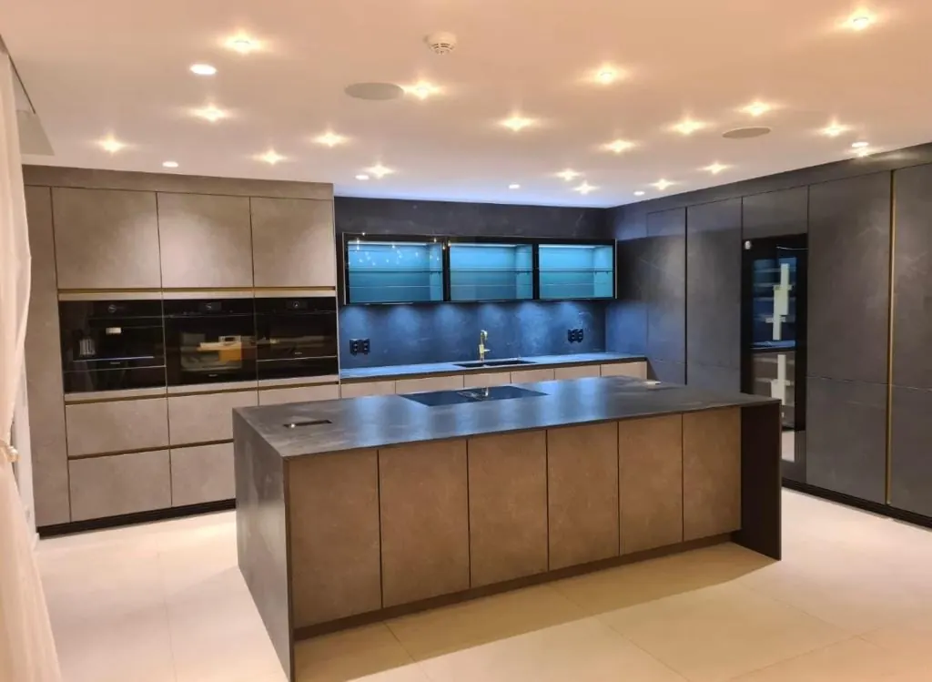 Kitchen with a bronze-finish island and dark stone worktop, built by Shadowbrook